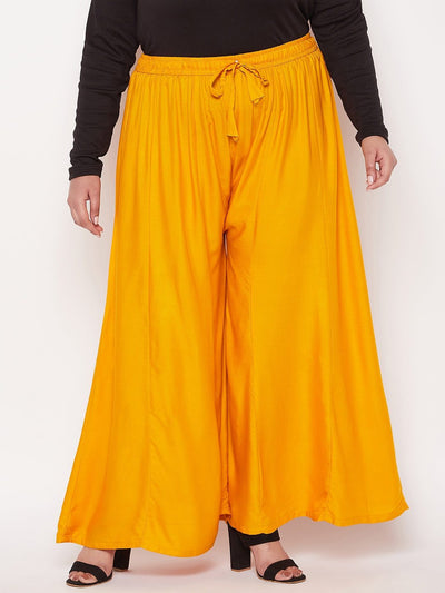 Mustard solid rayon flared sharara with elasticated waistband and drawstring.