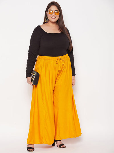 Mustard solid rayon flared sharara with elasticated waistband and drawstring.