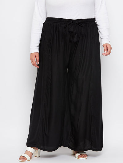 Black solid rayon flared sharara with elasticated waistband and drawstring.