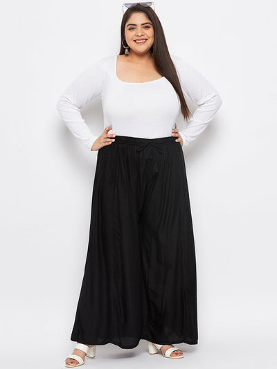 Black solid rayon flared sharara with elasticated waistband and drawstring.