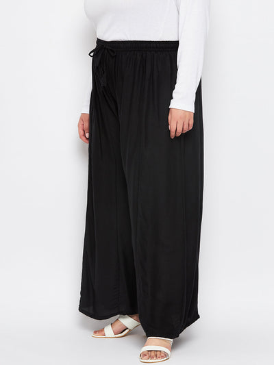 Black solid rayon flared sharara with elasticated waistband and drawstring.