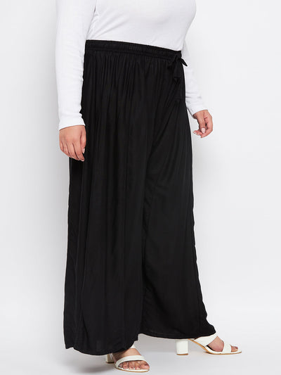 Black solid rayon flared sharara with elasticated waistband and drawstring.