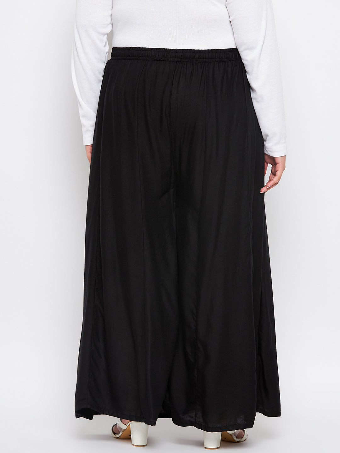 Black solid rayon flared sharara with elasticated waistband and drawstring.