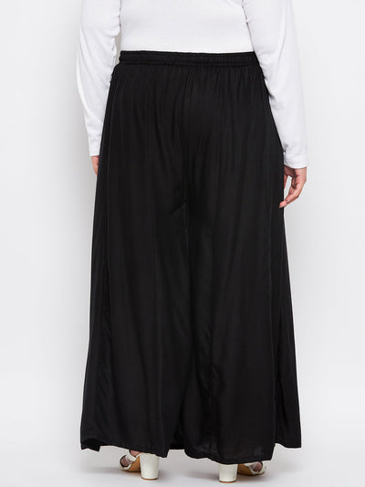 Black solid rayon flared sharara with elasticated waistband and drawstring.