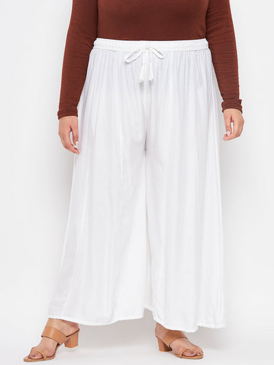 White solid rayon flared sharara with elasticated waistband and drawstring.