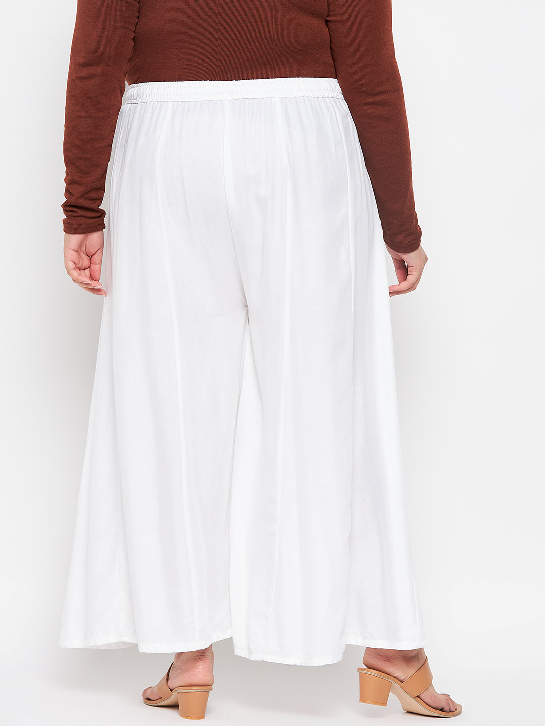 White solid rayon flared sharara with elasticated waistband and drawstring.