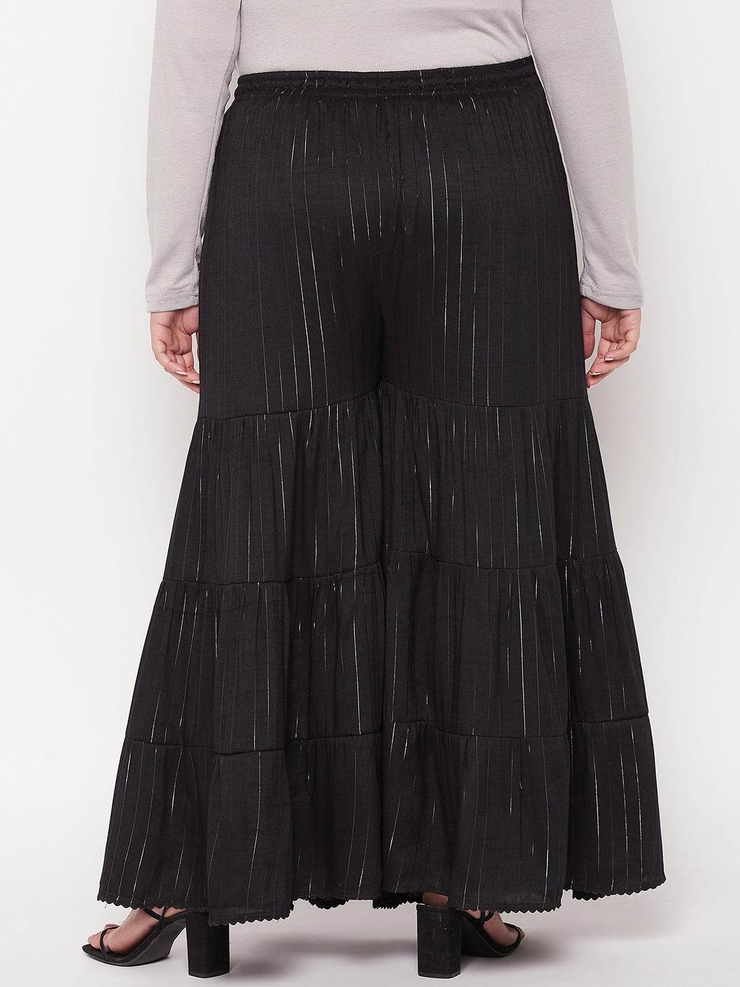 Black striped rayon flared gharara with elasticated waistband and drawstring.