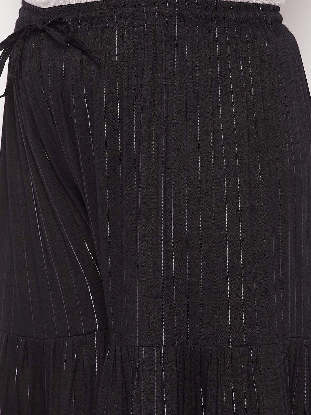 Black striped rayon flared gharara with elasticated waistband and drawstring.