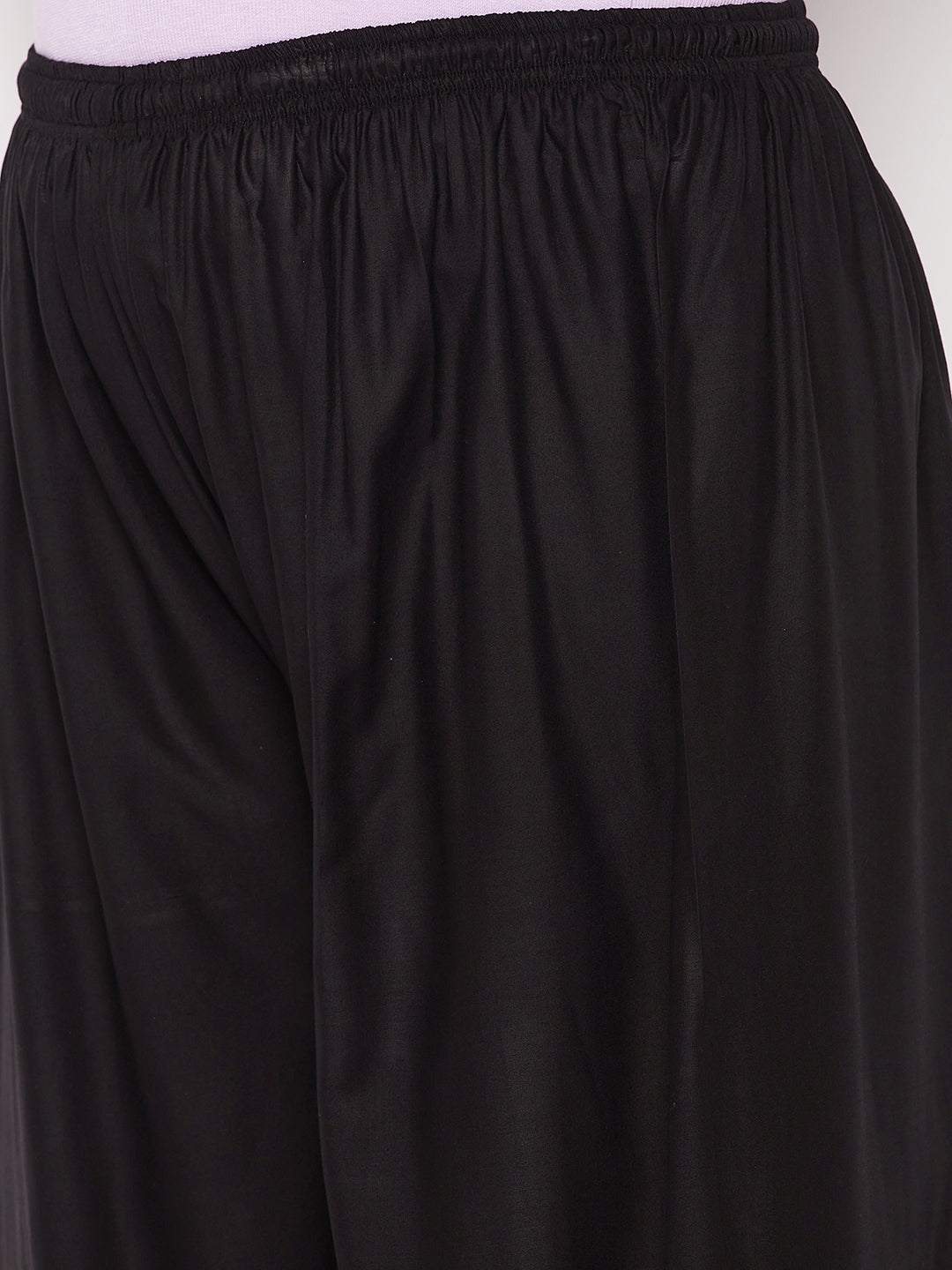 Black printed rayon palazzo with elastic waistband and drawstring.
