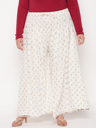 Cream polka dot rayon sharara with elastic waistband and drawstring.