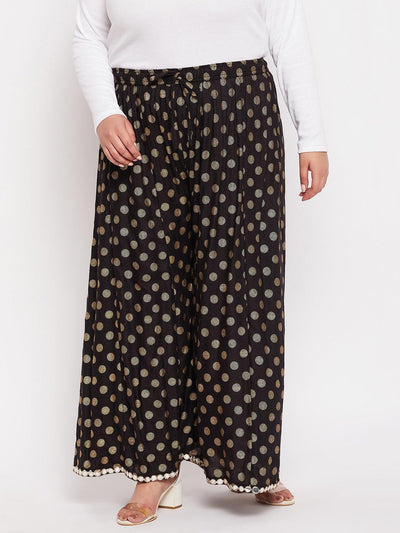 Black polka dot rayon sharara with wide leg design and elasticated waistband.