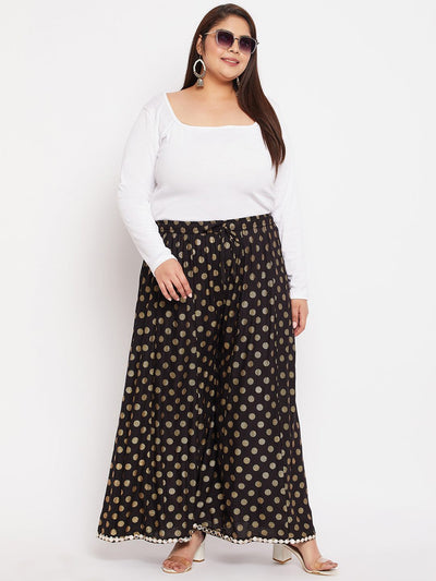 Black polka dot rayon sharara with wide legs and elasticated waistband.