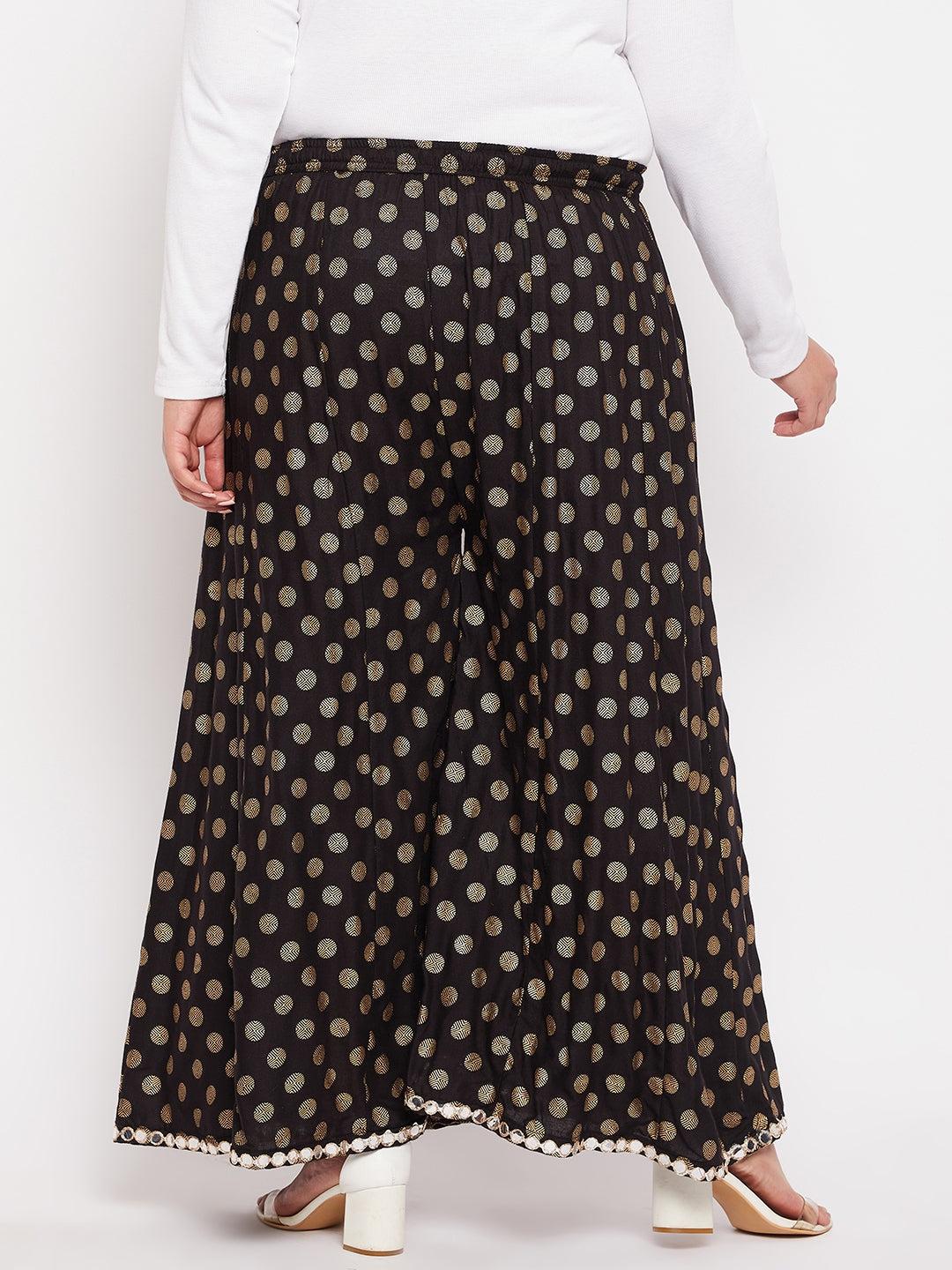 Black polka dot rayon sharara with elasticated waistband and drawstring.