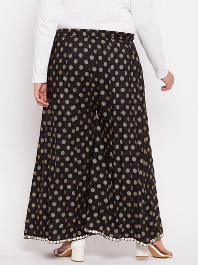 Black polka dot rayon sharara with elasticated waistband and drawstring.