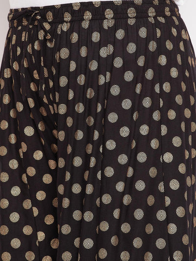 Black polka dot rayon sharara with elasticated waistband and drawstring.