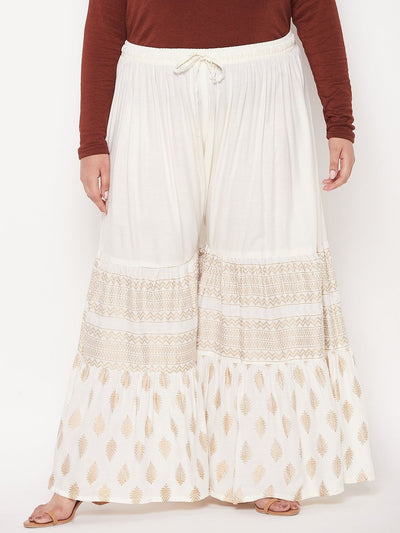 Cream printed rayon flared gharara with elastic waistband and drawstring.