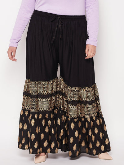 Black printed rayon flared gharara with elasticated waistband and drawstring.