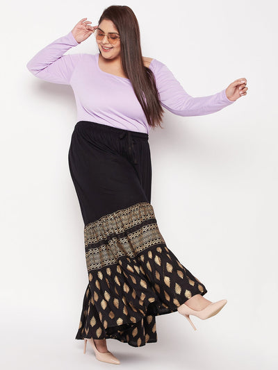 Black printed rayon flared gharara with elasticated waistband and drawstring.