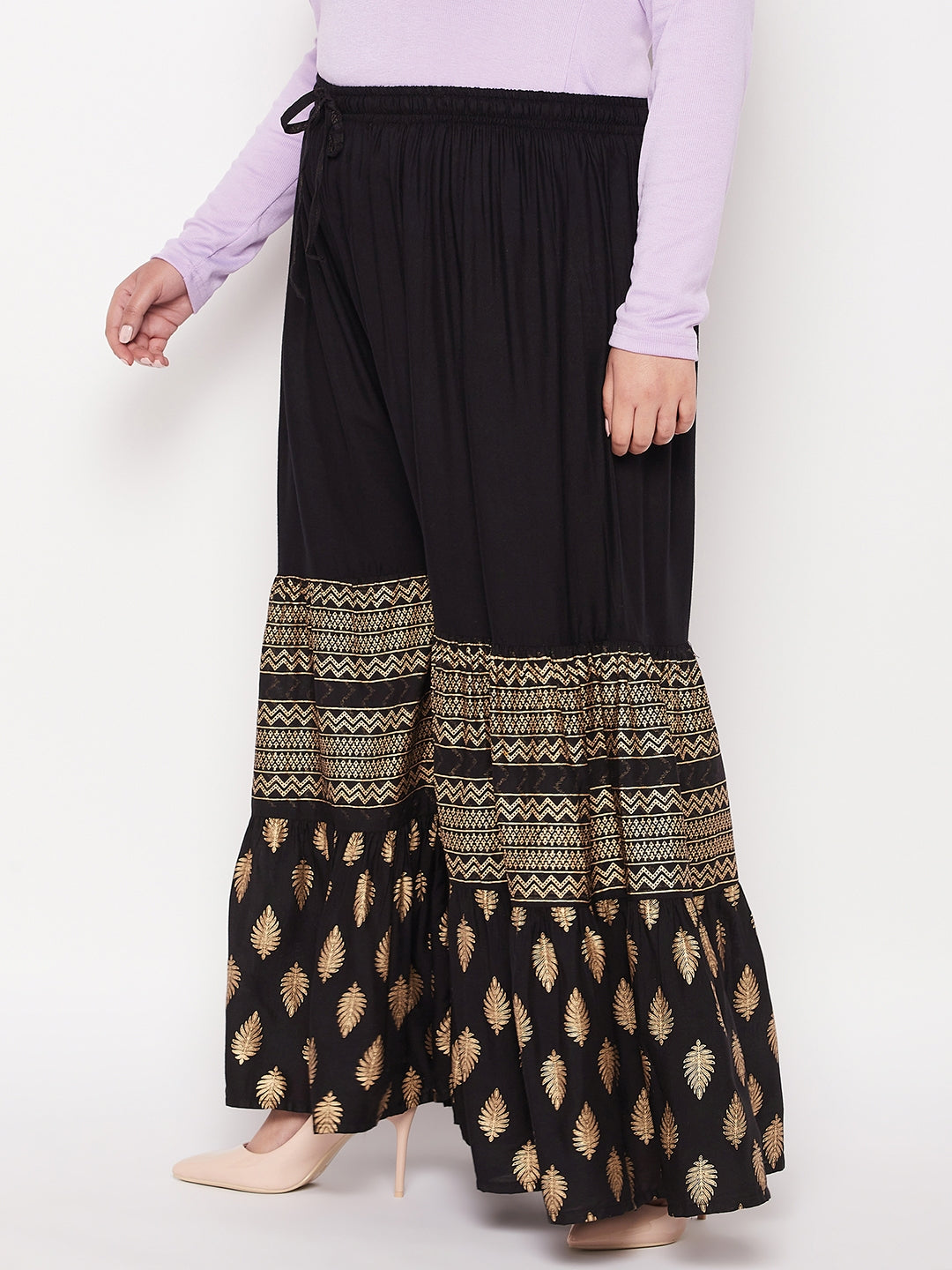 Black printed rayon flared gharara with elasticated waistband and drawstring.