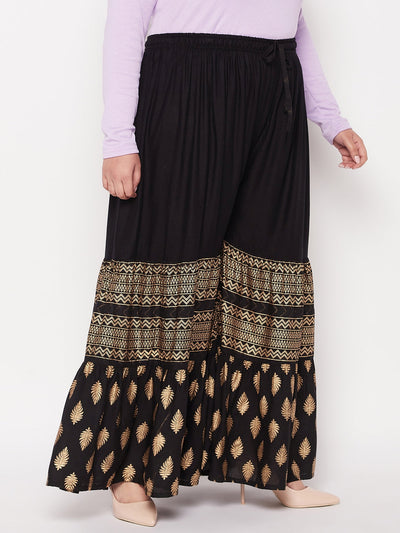 Black printed rayon flared gharara with elastic waistband.