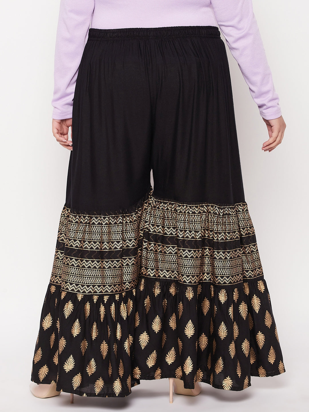 Black printed rayon flared gharara with elastic waistband and drawstring.