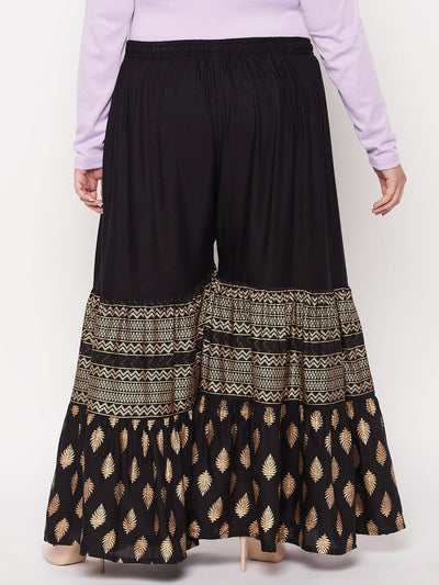 Black printed rayon flared gharara with elastic waistband and drawstring.