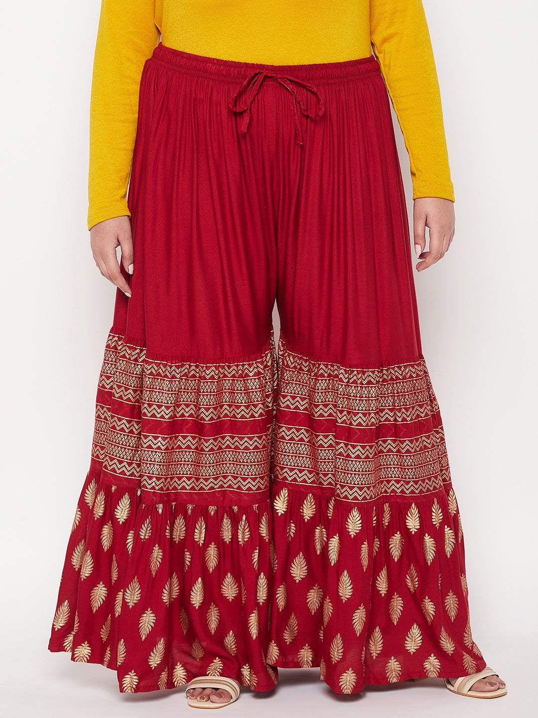 Maroon printed rayon flared gharara with elasticated waistband and drawstring.