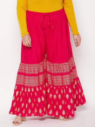 Magenta printed rayon flared gharara with elasticated waistband and drawstring.
